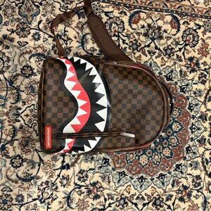 Sprayground Brown Checkered Backpack with Red and Black Shark Design
